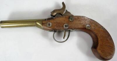 A 19thC brass and walnut pocket pistol, 19cm W and an eastern brass combination shot and powder flask of oval form. (2) - 3