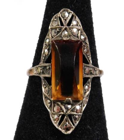 A 9ct gold and silver dress ring, with oval elongated design, with central orange paste stone and marqausite borders, ring size O.