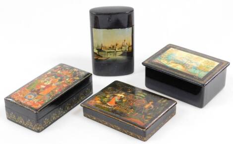 Various early 20thC Russian papier mache and other boxes, to include one with a lift off lid, hand painted with buildings probably the Kremlin, 11.5cm H, and three others. (4)