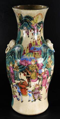 A Chinese pottery floor standing vase, the compressed trumpet stem flanked by moulded handles, the inverted shouldered circular body profusely decorated with various court figures before mountains, predominately in turquoise, blue and green, with characte