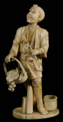 A late 19thC Japanese ivory okimono figure, with figure, a flower or fruit seller, 17cm H.