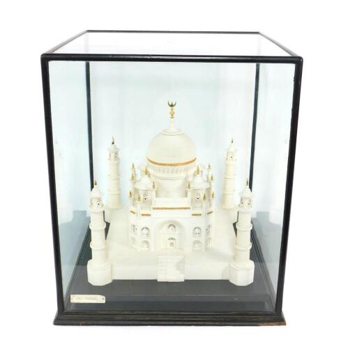 A scale model of the Taj Mahal, crafted out of sugar at the British Sugar Corporation, raised on a black base, within a glazed display cabinet, cabinet measures 59cm H, 51cm W, 52.5cm D.