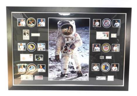 An Apollo Moon Landings collage, framed, including photographs of Astronauts, signed first day covers, and other autographs, etc, probably facsimiles, framed, 98cm x 150cm.