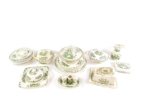 A Masons Ironstone green and white dinner service decorated in the Fruit Basket pattern, including a circular platter, three vegetable tureens and covers, condiment set, butter dish and cover, plates, etc. (qty)