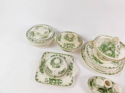 A Masons Ironstone green and white dinner service decorated in the Fruit Basket pattern, including a circular platter, three vegetable tureens and covers, condiment set, butter dish and cover, plates, etc. (qty) - 3