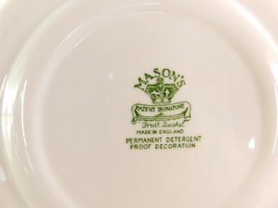 A Masons Ironstone green and white dinner service decorated in the Fruit Basket pattern, including a circular platter, three vegetable tureens and covers, condiment set, butter dish and cover, plates, etc. (qty) - 4