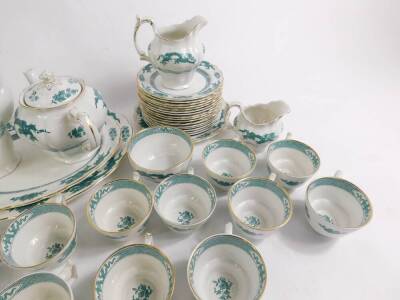 A Booths Pottery part dinner tea and coffee service decorated in the Dragon pattern, including tea and coffee pots, including two graduated meat platters, cups, saucers and plates. (qty) - 3