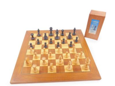 A Gibsons boxwood Staunton pattern chess set, boxed, together with a wooden chess board, 50cm x 50cm. (2)