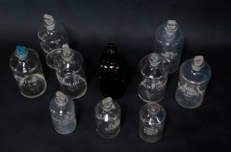 Ten glass apothecary or chemist's bottles, including a poison bottle, the others named for acids and tinctures, with stoppers.