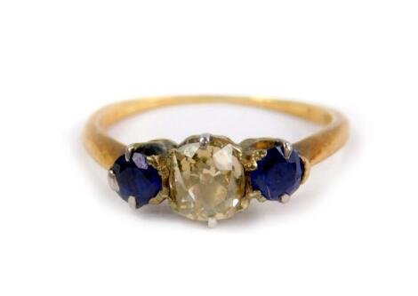 An 18ct gold diamond and sapphire three stone ring, the rose cut diamond approx 3/4cts, size M, 2.5g.