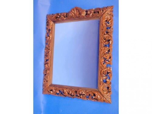 An Italianate carved walnut wall mirror