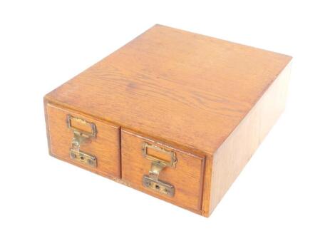 An Advanced Systems early 20thC oak two drawer filing cabinet, with brass fittings, 33cm W, 42cm D.