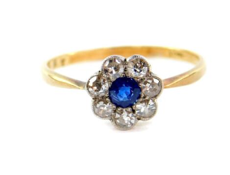 An 18ct gold sapphire and diamond ring, in a flower head design, diamonds approx 7/8cts, 2.8g.