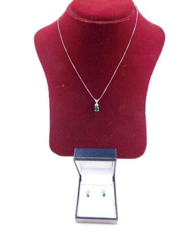A 9ct white gold emerald and diamond pendant on chain, and pair of matching earrings, 3g.