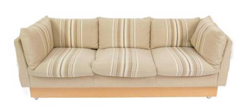 A 1970's beech framed three seater sofa, upholstered in striped beige fabric, 212cm W, 81cm D.