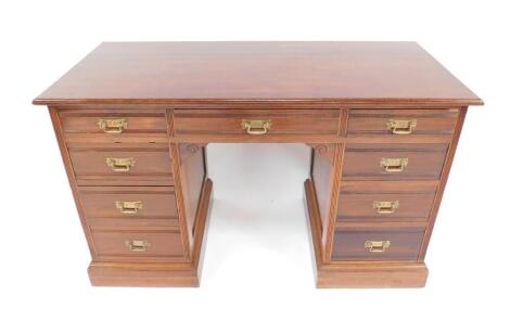 A Victorian oak twin pedestal desk, with one long and eight short drawers, raised on plinth bases, 75cm H, 122cm W, 54cm D.