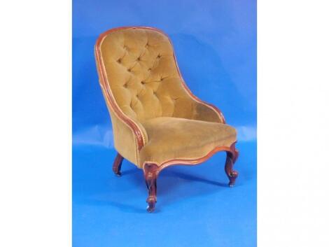 A Victorian walnut framed nursing chair with serpentine seats and scroll legs