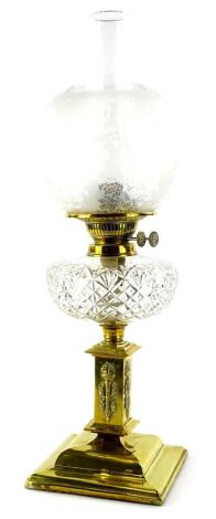 A Victorian brass oil lamp, with a part frosted shade, cut glass reservoir, the base decorated with flaming torch and stepped foot, 58cm H overall.