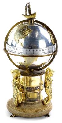 A St James House Co. annular clock, produced in 1984, limited edition, the silvered globe mounted with a two masted galleon and with gilt continents etc., on three mermaid supports with oak plinth and scroll cast feet, 38cm H.