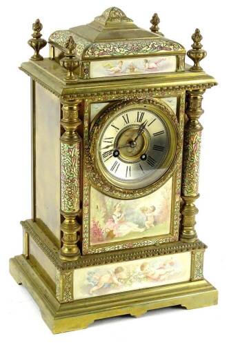 An early 20thC French gilt brass and champleve enamel mantel clock, the silvered dial with Roman numerals, the case mounted with porcelain panels, each decorated with putti, figures etc., indistinctly signed Lucat?, with urn and flame finial's, turned pil