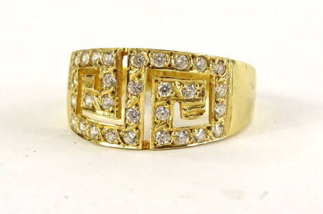 A Greek design dress ring, set with tiny diamonds, on a yellow metal band, marked 585, ring size T, 4.3g all in.