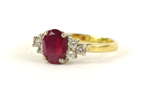 An 18ct gold ruby and diamond ring, with oval cut ruby in claw setting, flanked by three tiered diamond shoulders, in claw setting, ring size N, 3.8g all in.