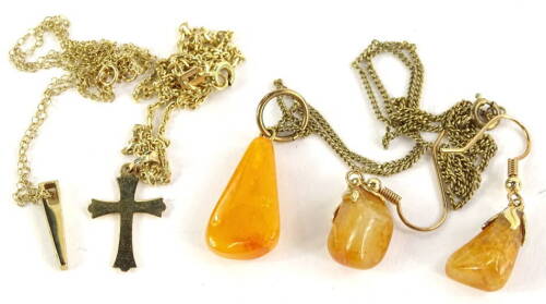 Various necklaces, to include a 9ct gold crucifix and chain, 3g, a 9ct gold pendant and chain, set with pink and white stones, 1.8g, and an imitation amber gold plated necklace and earring set. (4)