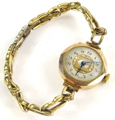 A wristwatch, in the 1950's/60's style with circular silvered dial, with etched Art Deco design motifs, blue hands, yellow metal, unmarked, on later expanding gold plated bracelet.