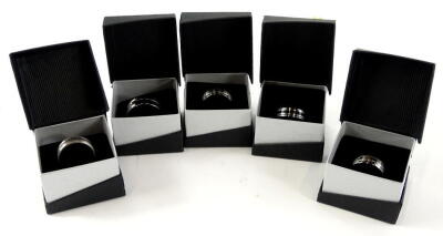 Five gent's dress rings, of varying design, in John Creed design boxes. (5)