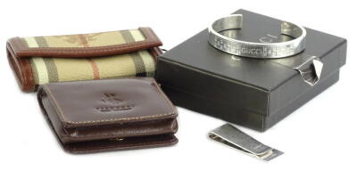 Withdrawn prior to sale. A Cartier silver money clip, a Burberry key holder, Gucci silver bracelet etc.