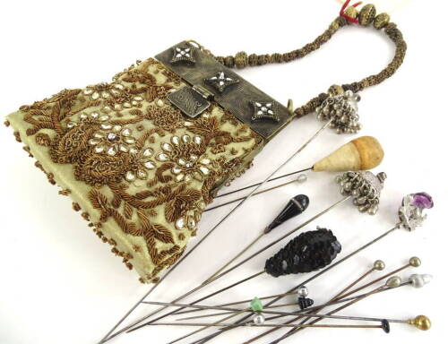 A quantity of hat pins, of varying design on stainless steel pins, and a beaded evening purse with Mimu tag.