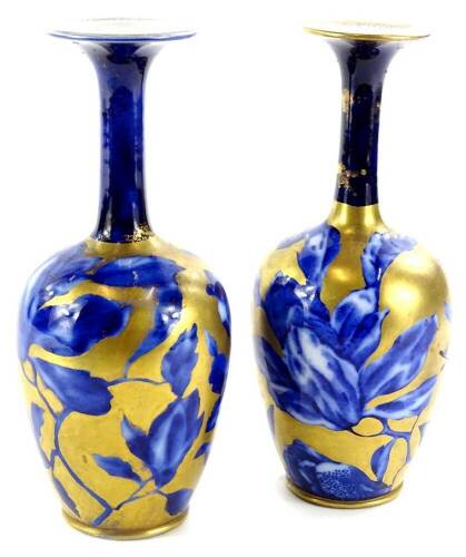 A pair of late 19th/early 20thC flow blue pottery vases, decorated in flowers, picked out in gilt, marks indistinct, 20cm H.