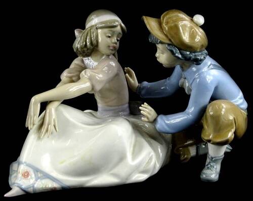 A Lladro porcelain figure group, modelled in the form of a young boy with a female dancer, 25cm W.