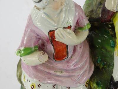 A 19thC Staffordshire pottery figure group, modelled in the form of a gentleman seated on a rock beside a lady, on square base, numbered 36 (AF), 22cm H. - 2