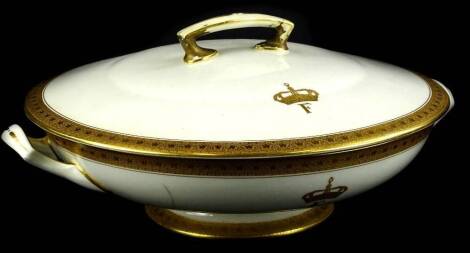 A Royal Worcester porcelain tureen and cover, retailed by Waring and Gillow, decorated to the lid and base with a crown and F, possibly for King Farouk of Egypt, 27cm W. (AF)