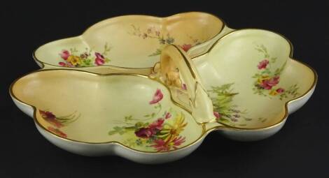 A Royal Worcester triple hors d'oeuvres dish, with a single handle painted with flower spray on a blush ivory ground, printed marks in puce to underside, 27cm W.