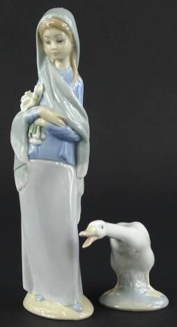 A Lladro porcelain figure of a girl carrying lilies (AF), and a Lladro goose. (2)