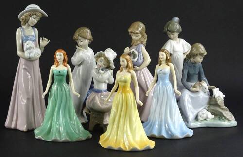 A collection of Nao ceramic figures, to include girls with puppies and three Royal Doulton figurines. (9)