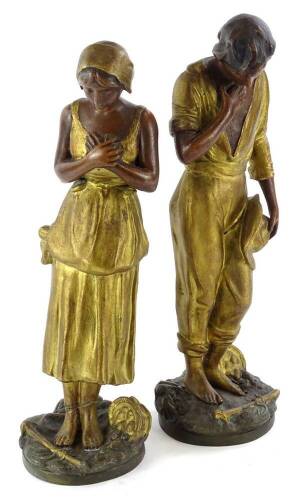 A pair of late 19thC gilt spelter figures, modelled in the form of a gentleman and a lady, each on a circular base cast with a basket, (AF), 36cm H.