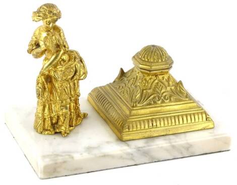 A late 19thC French marble inkstand, mounted with a gilt metal figure of a lady and a separate domed inkwell cast with scrolls etc.