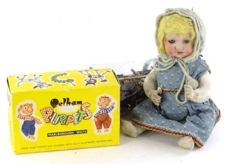 A German bisque headed doll, with composition limbs, (AF), a Pelham Bengo puppet in original box.