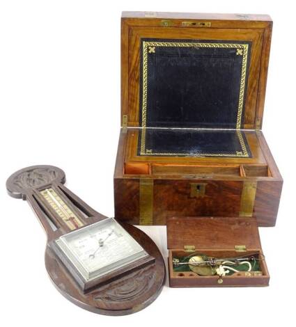 A Victorian walnut and brass writing box, 30cm W, a set of 19thC brass portable scales in mahogany box and an Art Nouveau style carved oak barometer. (3)