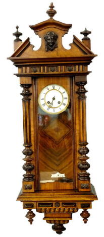 A late 19thC Vienna wall clock, in a walnut case, the crest decorated with a composition mast above enamel dial, flanked by reeded and part turned pilasters, 101cm H.