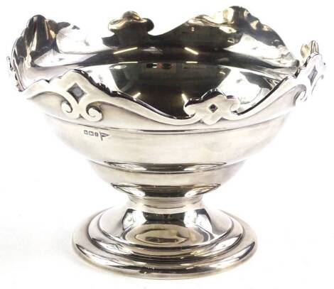 A George V silver bowl, with the shaped border decorated with scrolls etc., on a domed foot, Sheffield 1915 by Walker and Hall, 11½oz, 18cm dia.