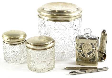 A collection of small silver and silver mounted items, to include dressing table jars, propelling pencils, a cigar cutter etc.