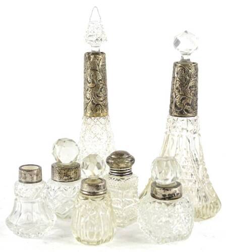 A collection of cut glass and silver mounted scent bottles, to include scent bottles and stoppers etc., to include a pair of tapering examples etc. (7)