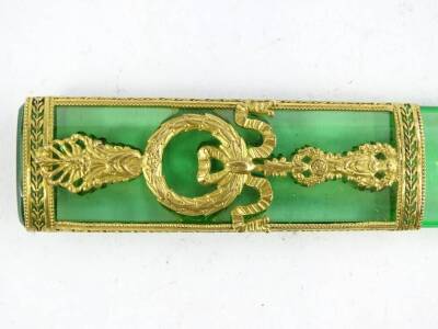 A French gilt metal and green glass page turner, decorated with breeze, bows, swags etc., 22.5cm L, in a fabric case. - 2