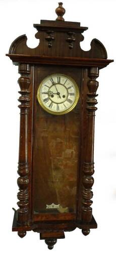 A late 19thC Gustav Becker Vienna wall clock, in a walnut case with shaped crest, Roman numerals to the enamel style dial and turned pilasters, with drop finial's, 125cm H.