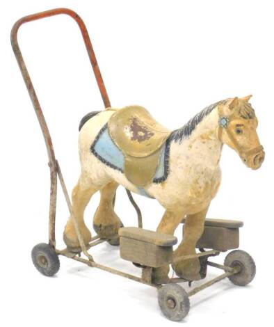 A Tri-ang composition push-a-long grey horse, with metal framework and plastic wheels, stamped to side, 66cm W.