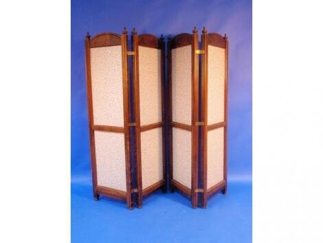 A folding screen of four panels each panel furbished with printed foliate material